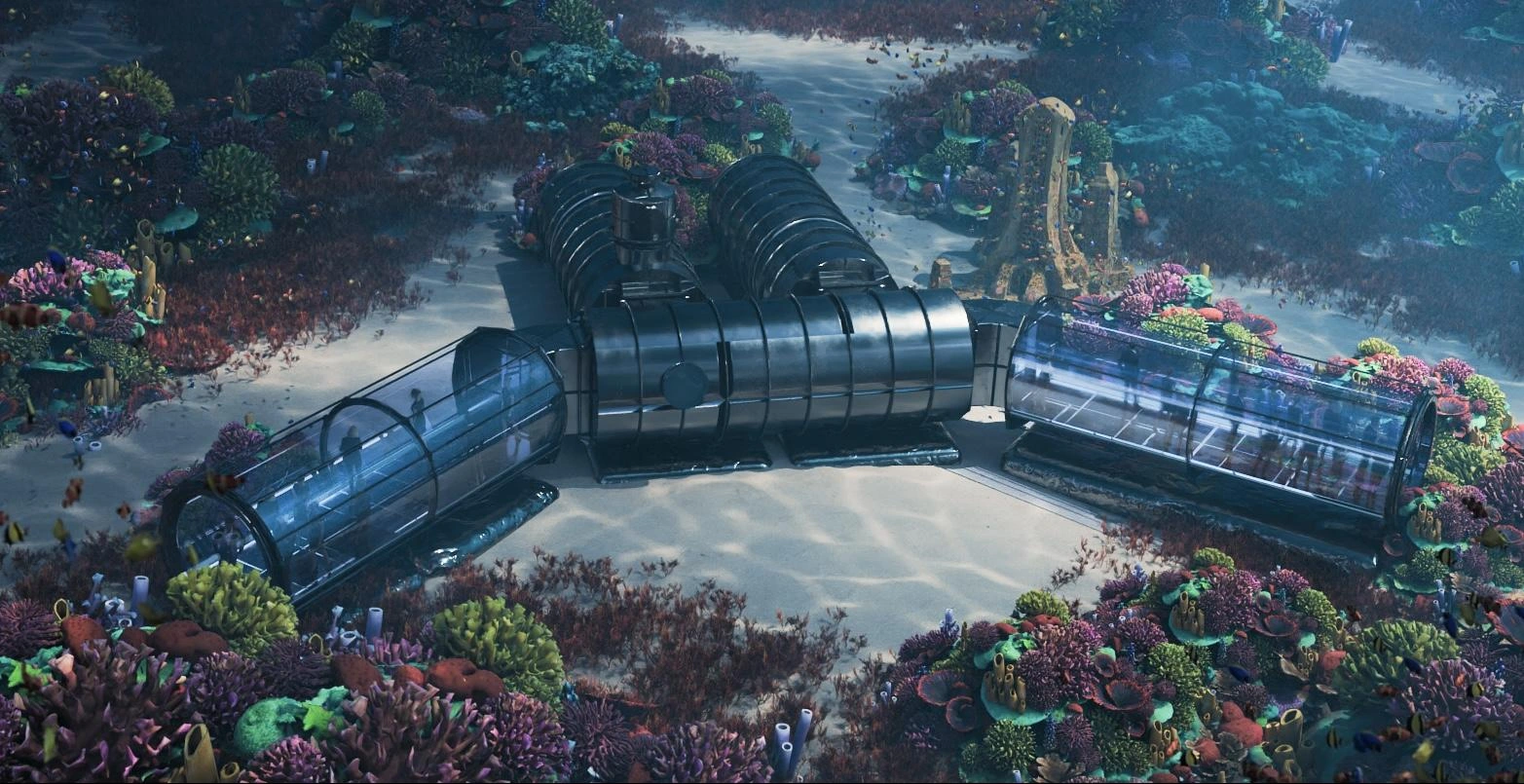Rendering of the habitat on a sandy patch between coral: two transparent acrylic modules angle out from a central steel module, with two steel modules behind.