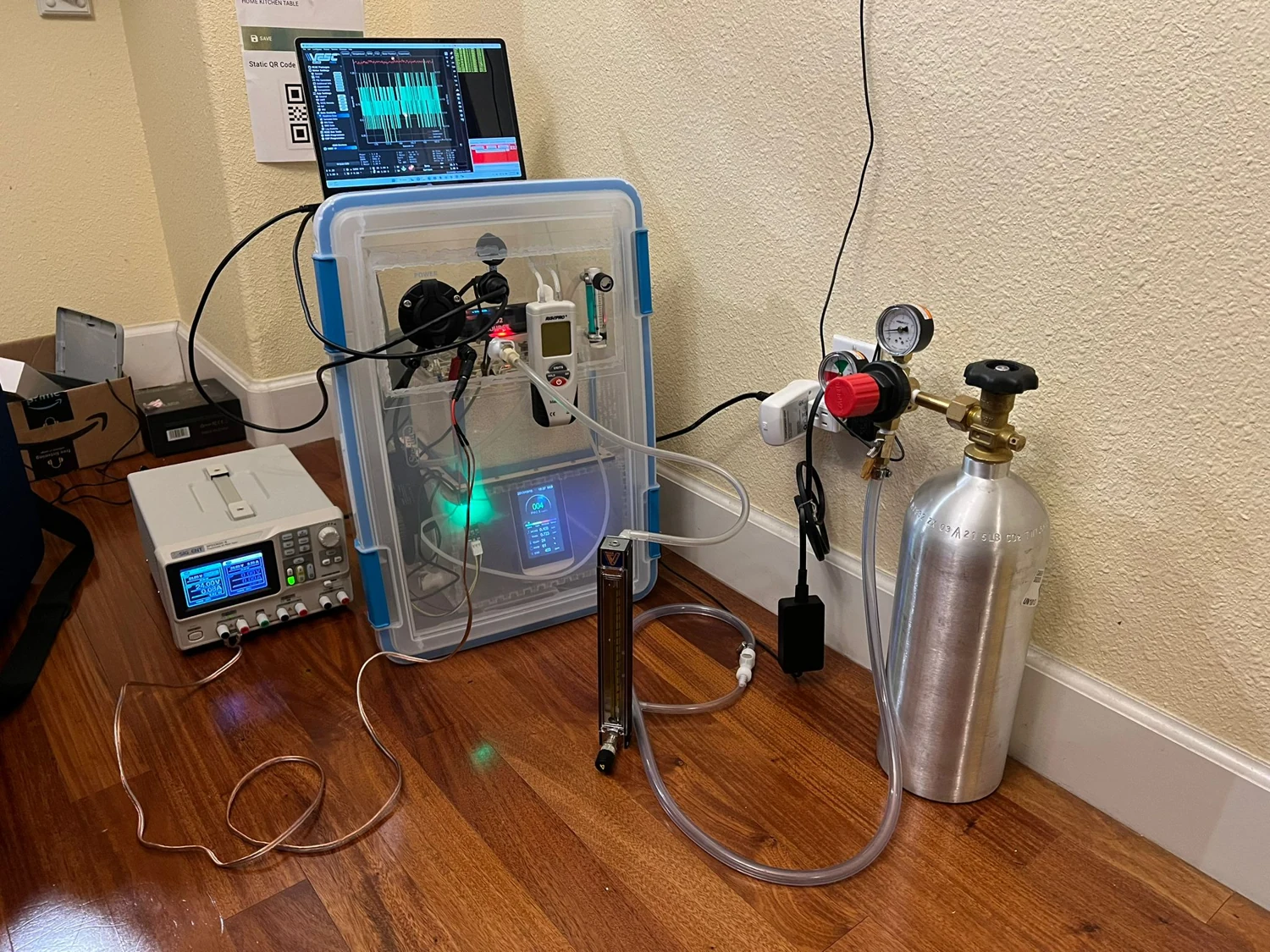 Photograph of the scrubber test bench with gas supply, instrumentation and a laptop.